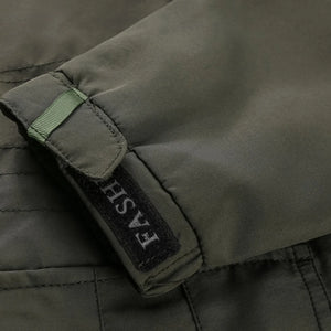 Close-up of a green jacket with a brand label on a dark background