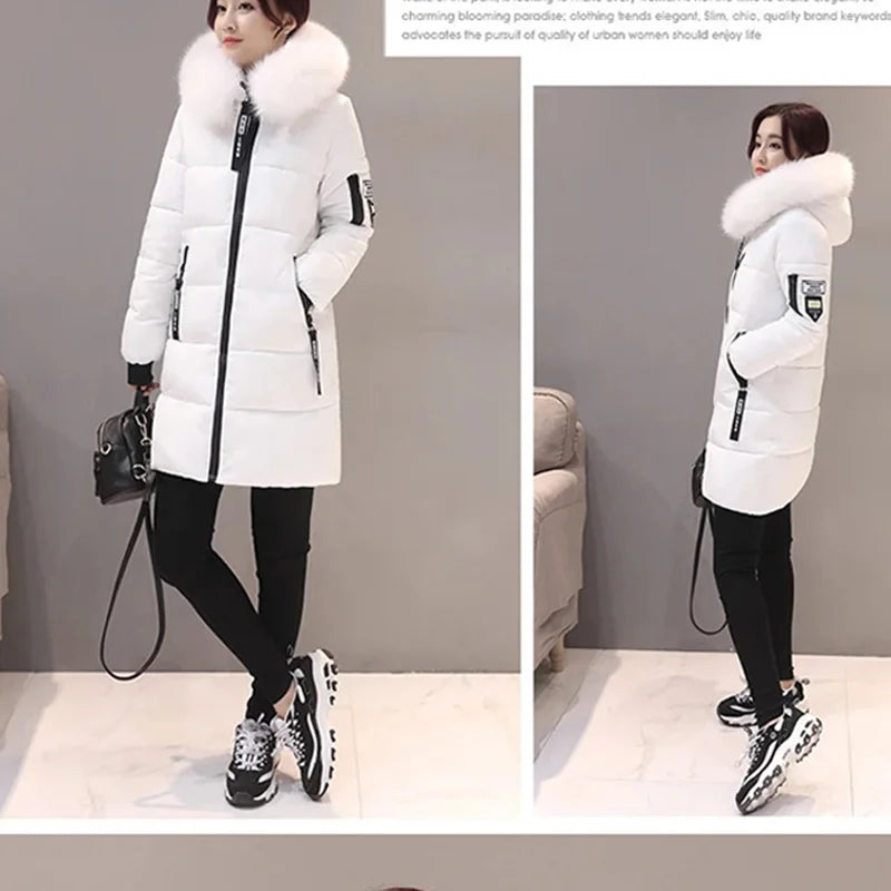 White winter coat with fur hood worn by a model against a neutral background