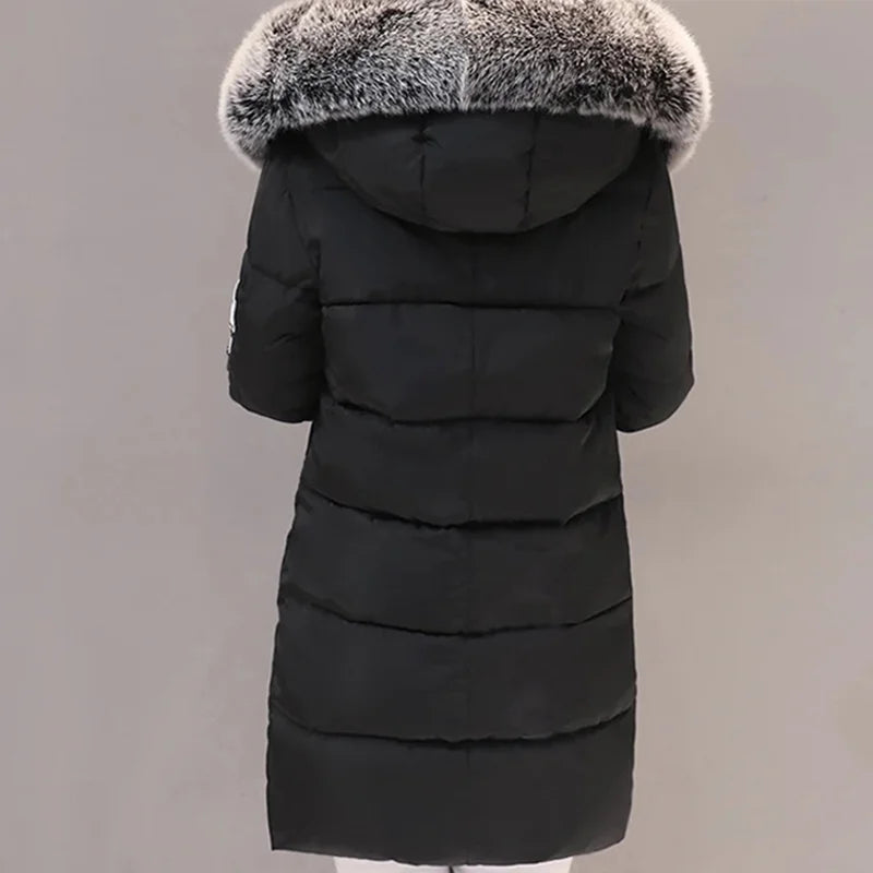 Black winter coat with fur hood on a gray background