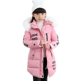 Pink winter coat with fur hood worn by a child on a white background