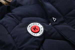 Navy blue jacket with a brand logo on a dark background