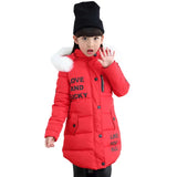 Child wearing a red winter coat with text, black hat, and white fur trim on a white background