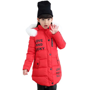 Child wearing a red winter coat with text, black hat, and white fur trim on a white background