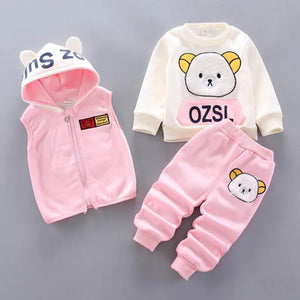 Children's pink and white outfit with bear design on a gray background