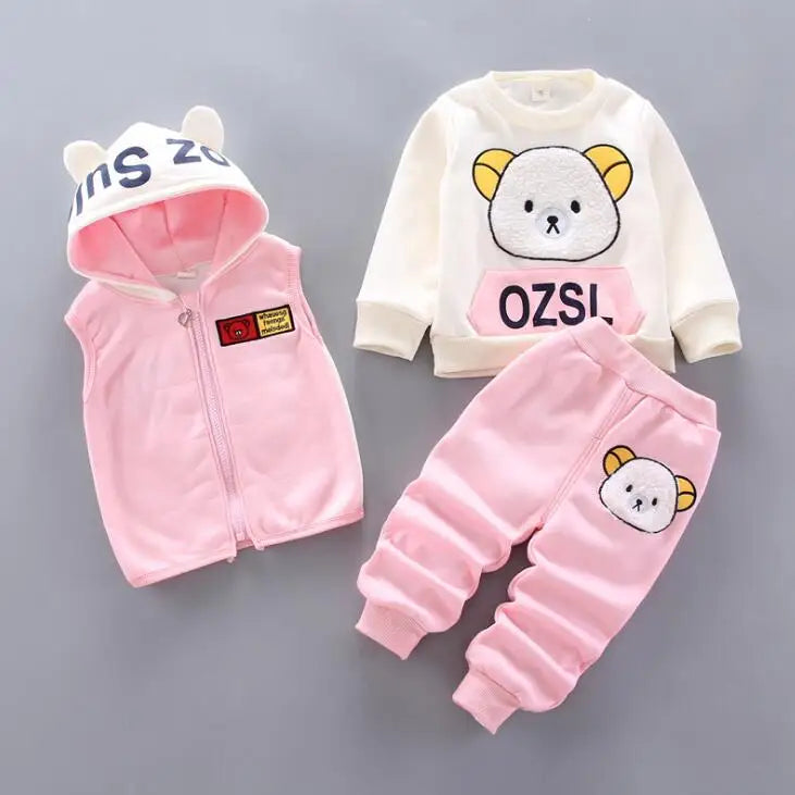 Children's pink and white outfit with cartoon design on a gray background