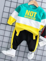Children's outfit with 'NOT INTERESTED' text on a checkered background
