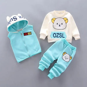 Children's clothing set with light blue vest, white shirt, and pants on a gray background