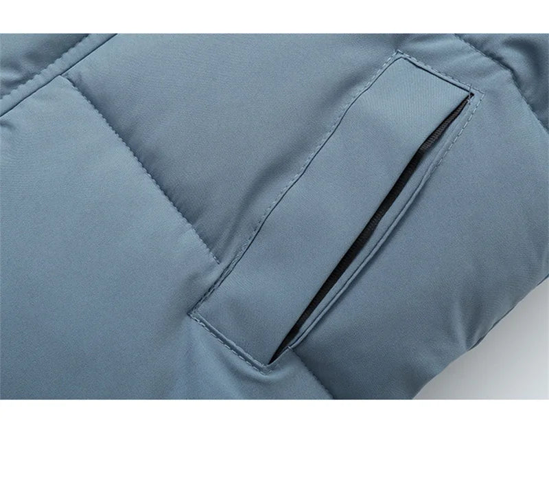 Close-up of a blue quilted jacket with a pocket on a white background