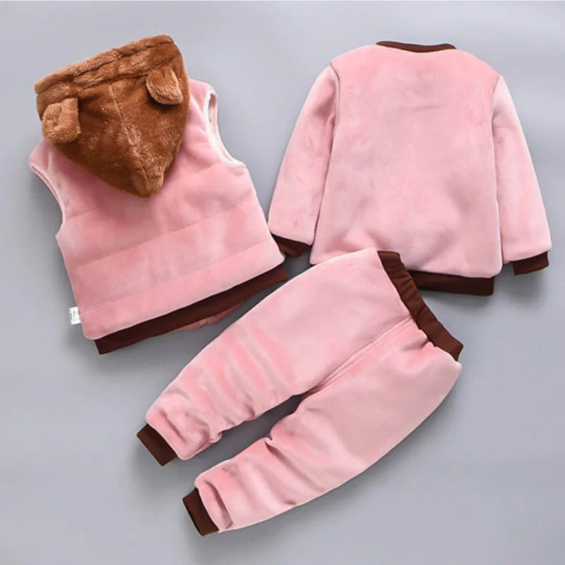 Pink children's outfit with brown accents on a gray background