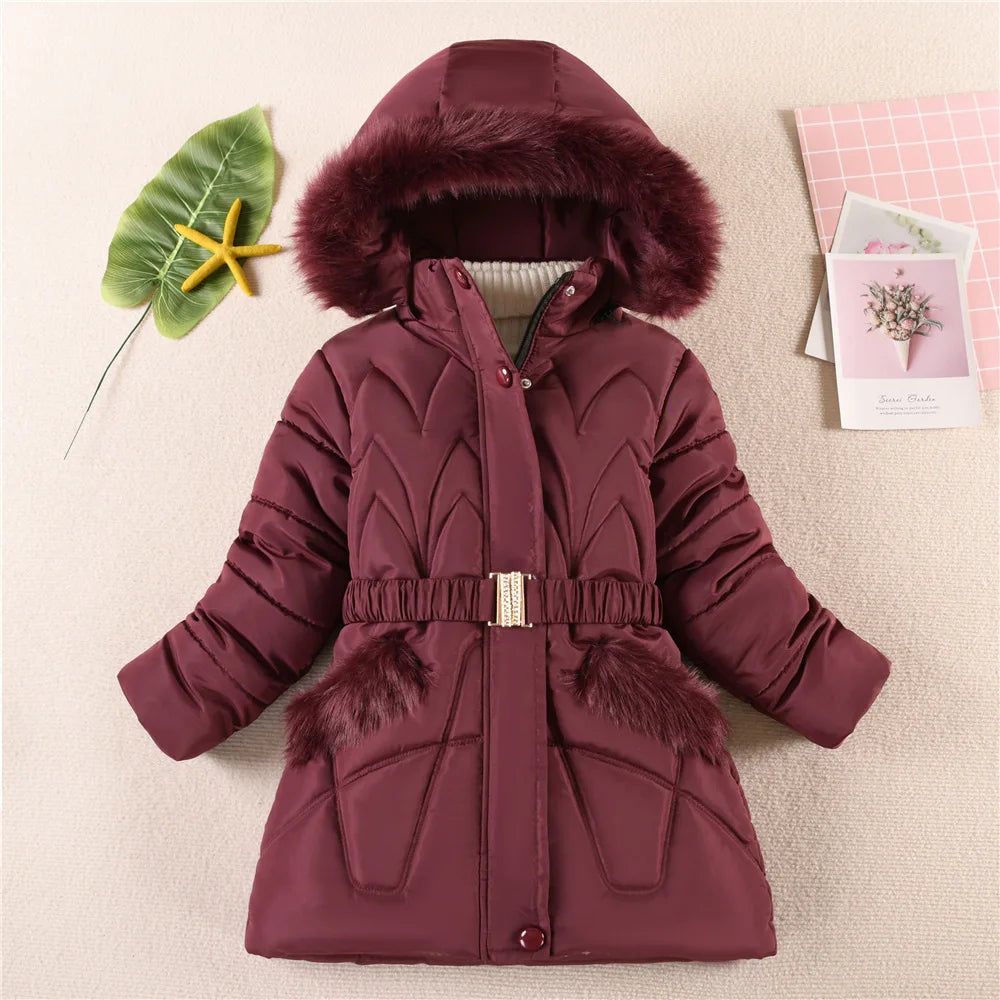 Maroon winter coat with fur trim on a beige background