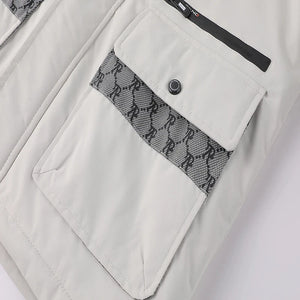 Close-up of a light gray jacket with a patterned pocket flap on a white background