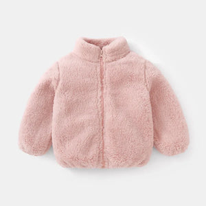 Pink fluffy jacket on a light gray background
