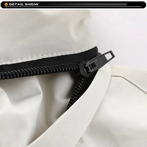 Close-up of a black zipper on a white fabric background