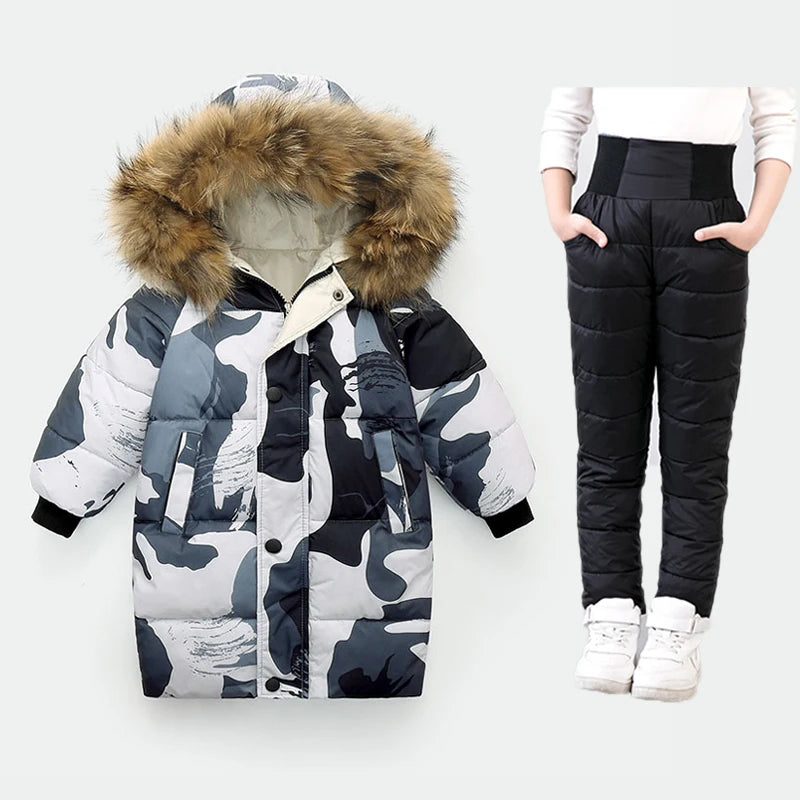 Camouflage puffer jacket with fur hood and black puffer pants on a white background