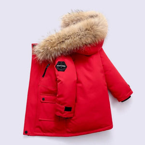 Red children's parka with fur hood on a light gray background