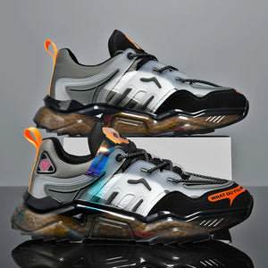 Pair of futuristic sneakers with reflective surfaces on a gray background