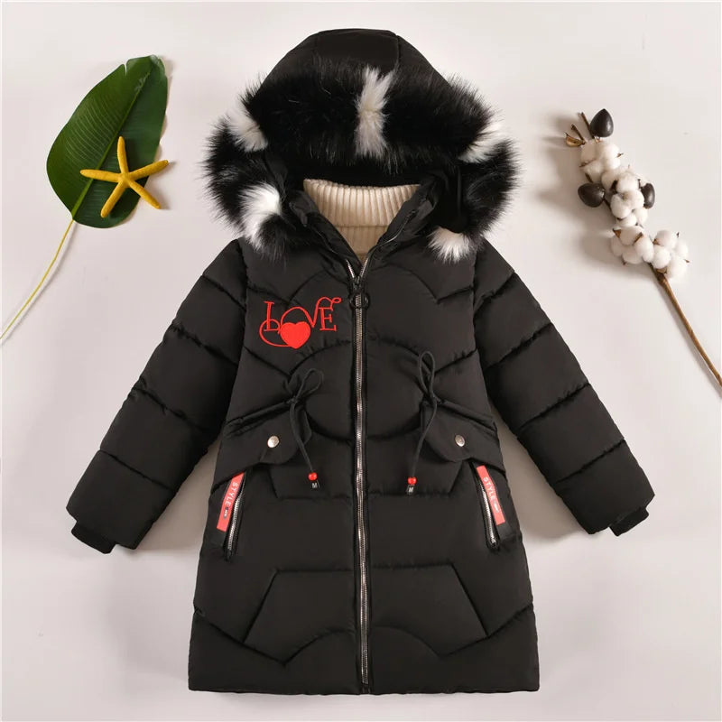 Black puffer jacket with fur hood on a light gray background
