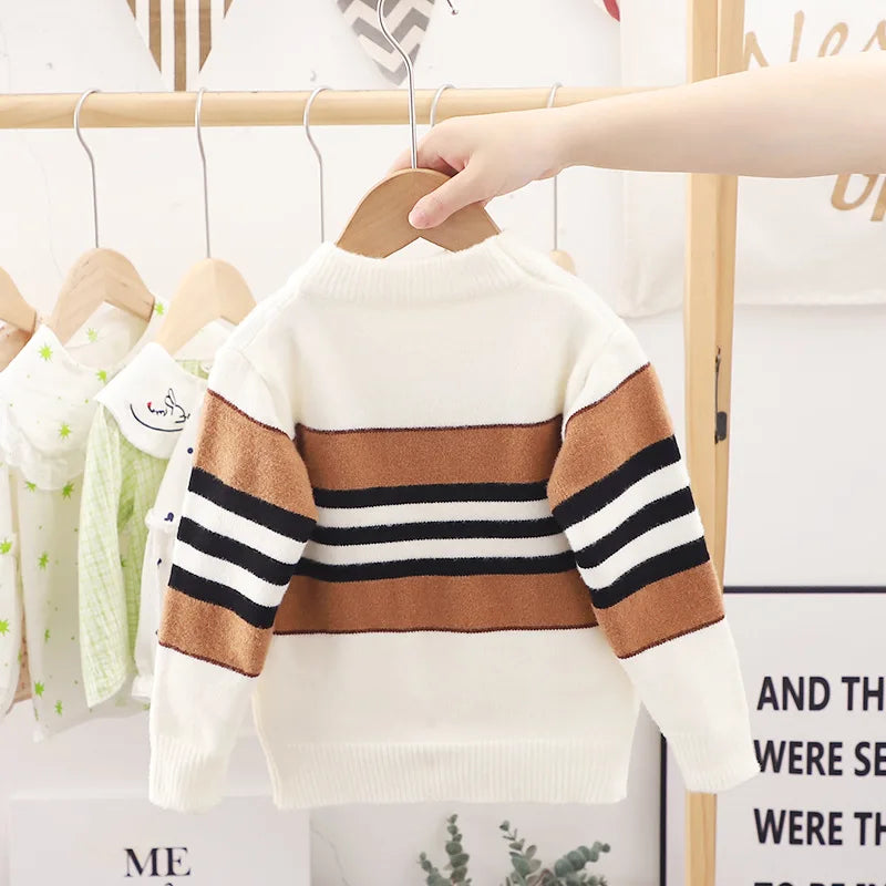 Children's sweater with striped pattern on a hanger