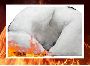 Close-up of a penguin's face with snow and flames in the background