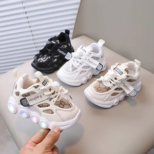 Children's LED sneakers on a light surface with a neutral background