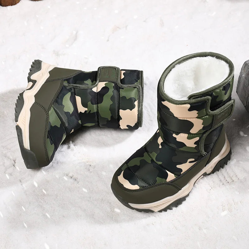 Camouflage-patterned boots with white fur lining on a snowy background