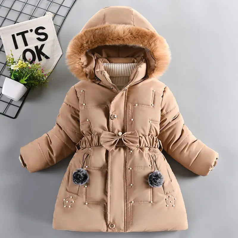 Beige winter coat with fur hood on a gray background