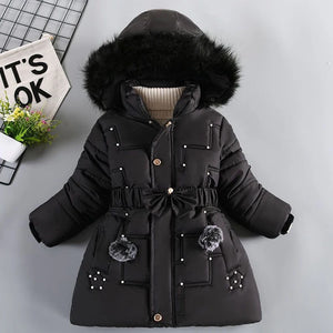 Black winter coat with fur hood on a light gray background
