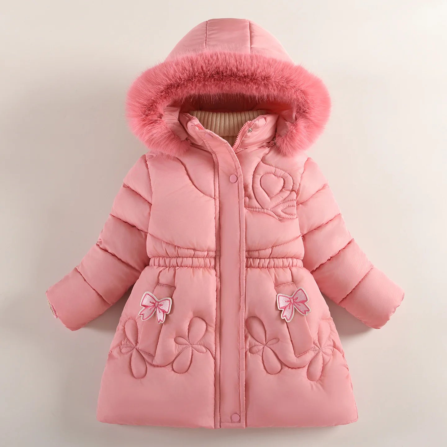Pink children's coat with fur hood on a light beige background