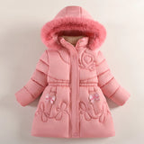 Pink children's coat with fur hood on a light beige background