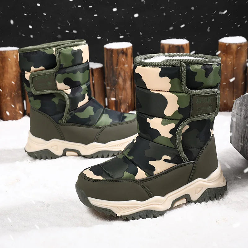 Camouflage snow boots on a snowy background with wooden logs.