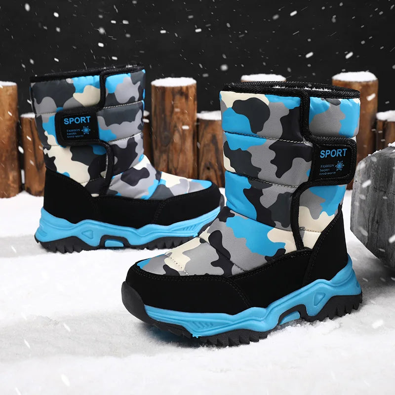 Camouflage-patterned snow boots with blue accents on a snowy background