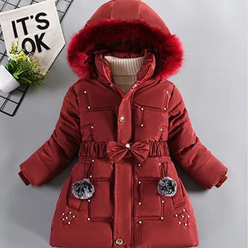Red children's coat with a hood on a light gray background