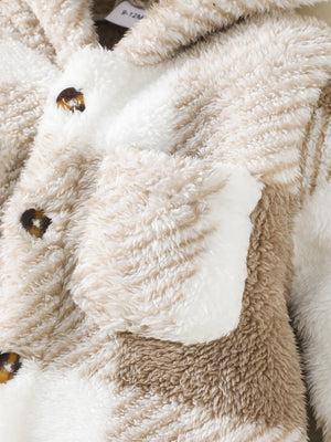 Close-up of a fluffy, beige and white animal-shaped blanket with a bee design.