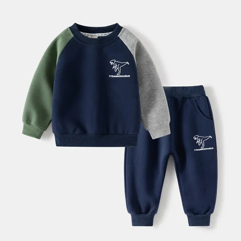 Children's navy and green sweatshirt and pants set with dinosaur design on a white background