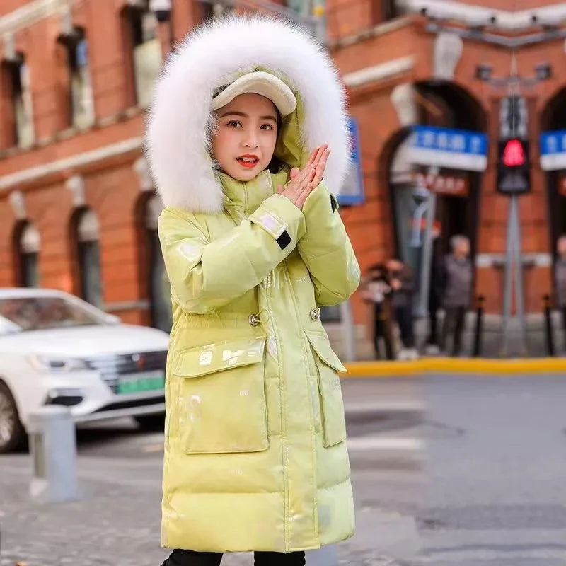 Person wearing a bright yellow winter coat with a large fur hood on a city street.