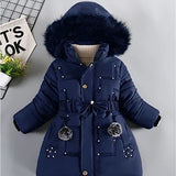 Navy blue winter coat with fur hood on a light gray background