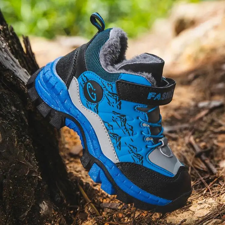 Blue and black children's hiking boot on a natural background