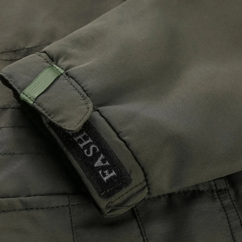 Close-up of a green jacket with a brand label on a dark background