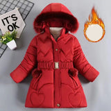 Red winter coat with fur trim on a gray background