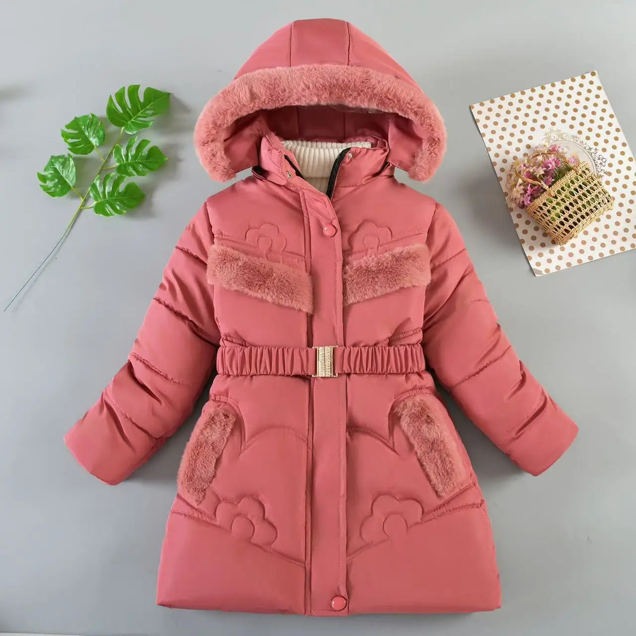 Pink children's winter coat with fur-lined hood on a gray background