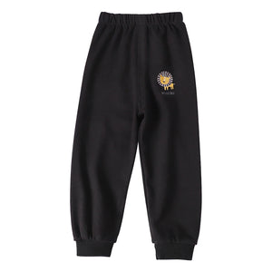 Black sweatpants with a yellow lion logo on a white background