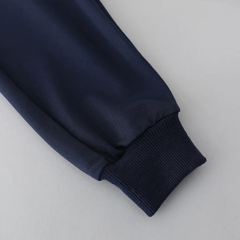 Navy blue sweatshirt sleeve on a light gray background
