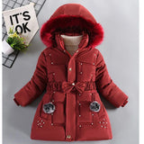 Red winter coat with fur hood on a gray background