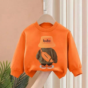 Orange sweatshirt with a graphic design of a child wearing a hat and holding a bag, hanging on a hanger against a neutral background.