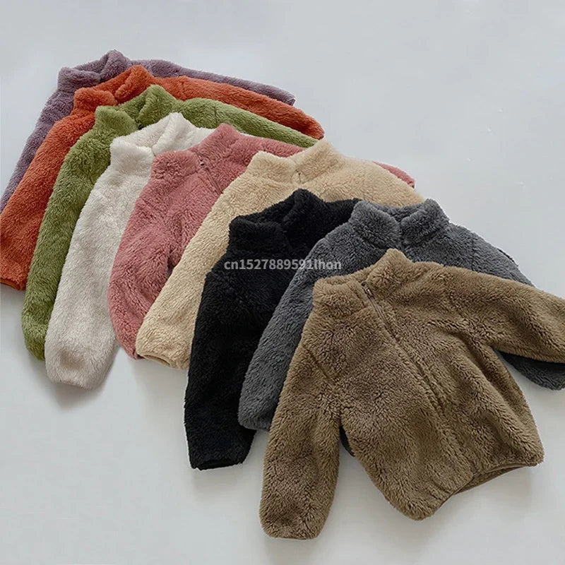 Row of colorful fleece blankets on a white background