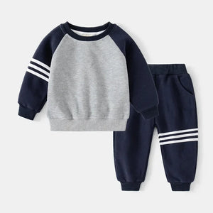 Children's navy and gray sweatshirt and pants set on a white background