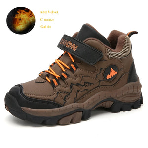 Brown children's hiking shoe with orange laces on a white background