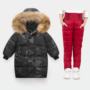 Black camouflage puffer coat with fur hood and red puffer pants on a white background