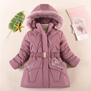Pink winter coat with fur trim on a light background