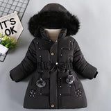 Black winter coat with fur hood on a light gray background